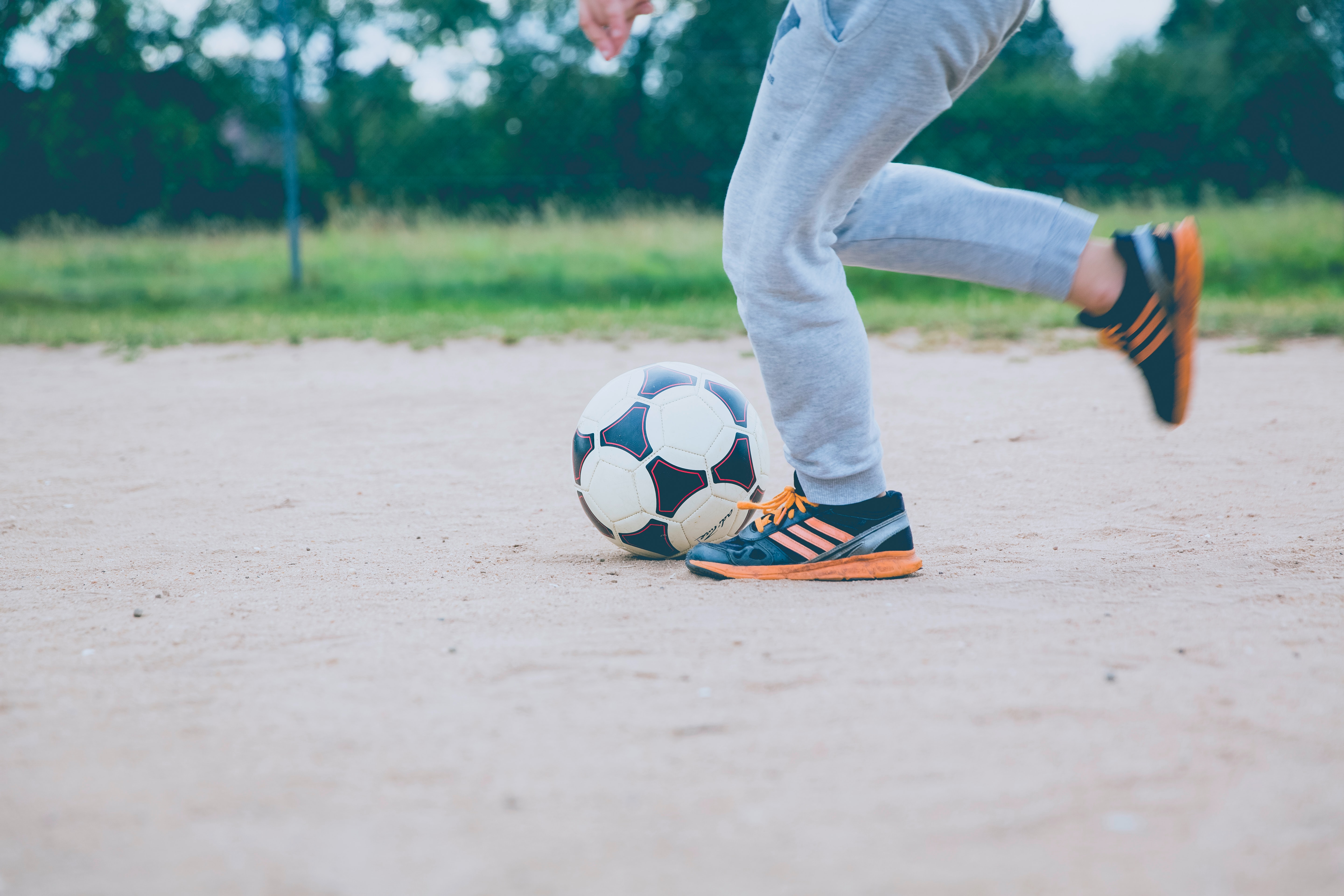 person kicking a football